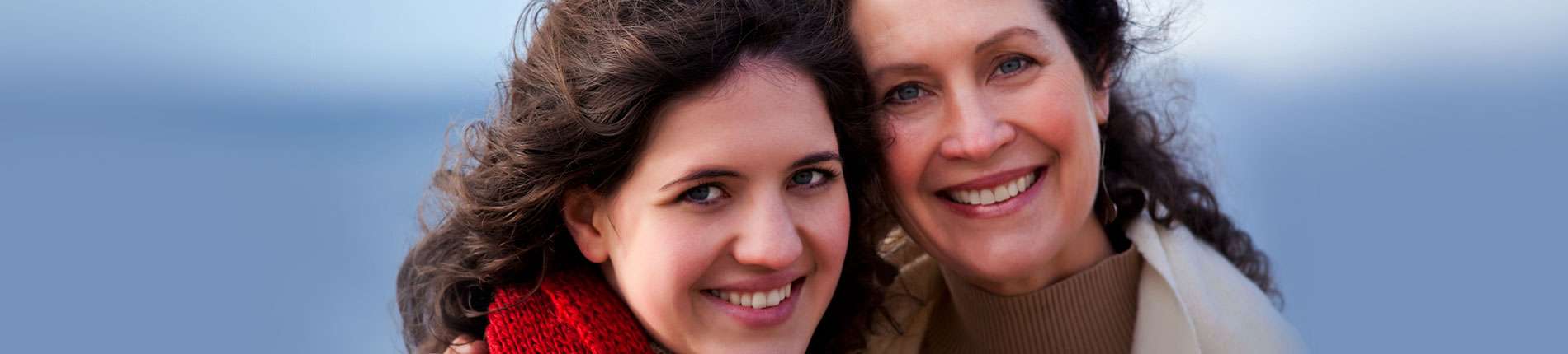 Stock image of two women smiling and holding each other